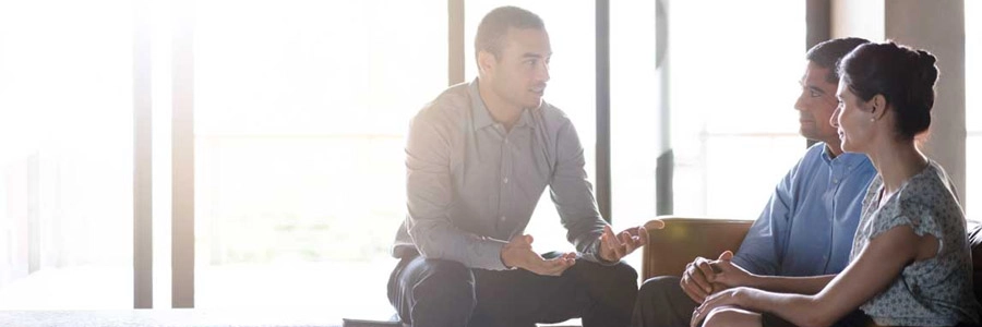 A small group sits together and engages in a supportive conversation