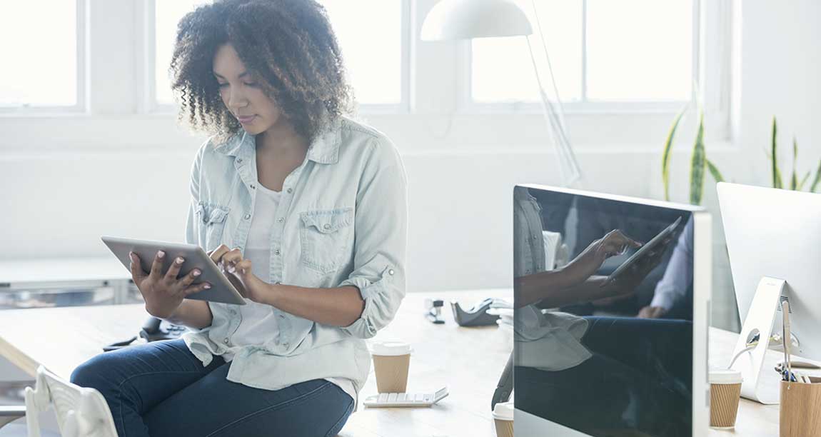 woman sits on desk