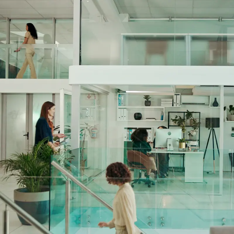 Business people walking in modern glass workplace