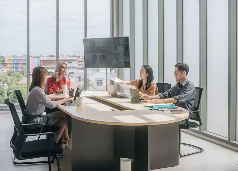 Group of business people having a meeting at their company