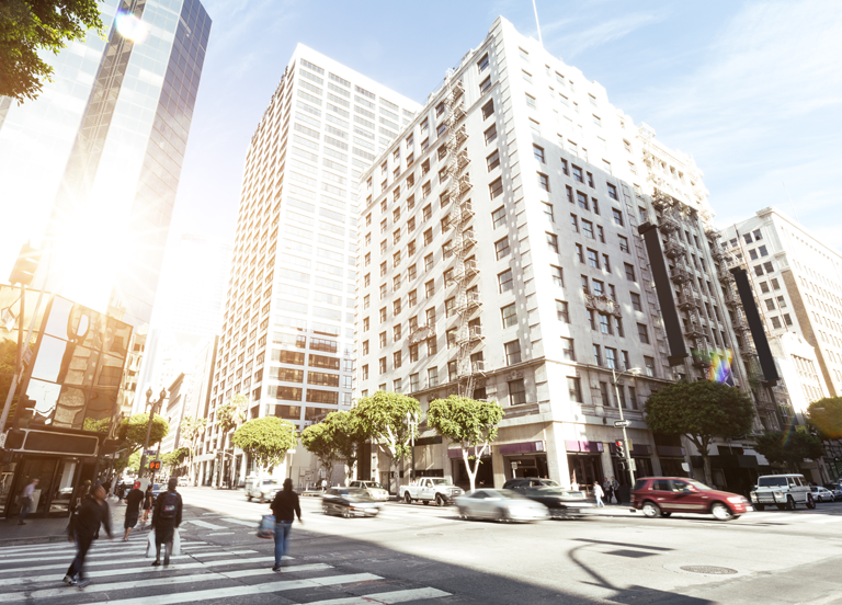 People at road intersection in Los Angeles at sunrise