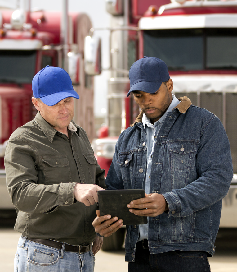 Two truck drivers using a tablet
