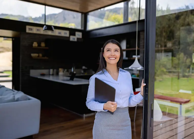 Happy real estate agent showing a property